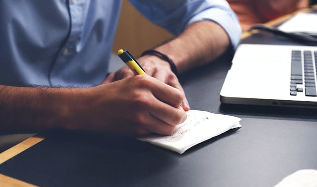 A man writing at his desk
